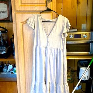 It’s a tan dress it has been worn out once it is by see you Monday